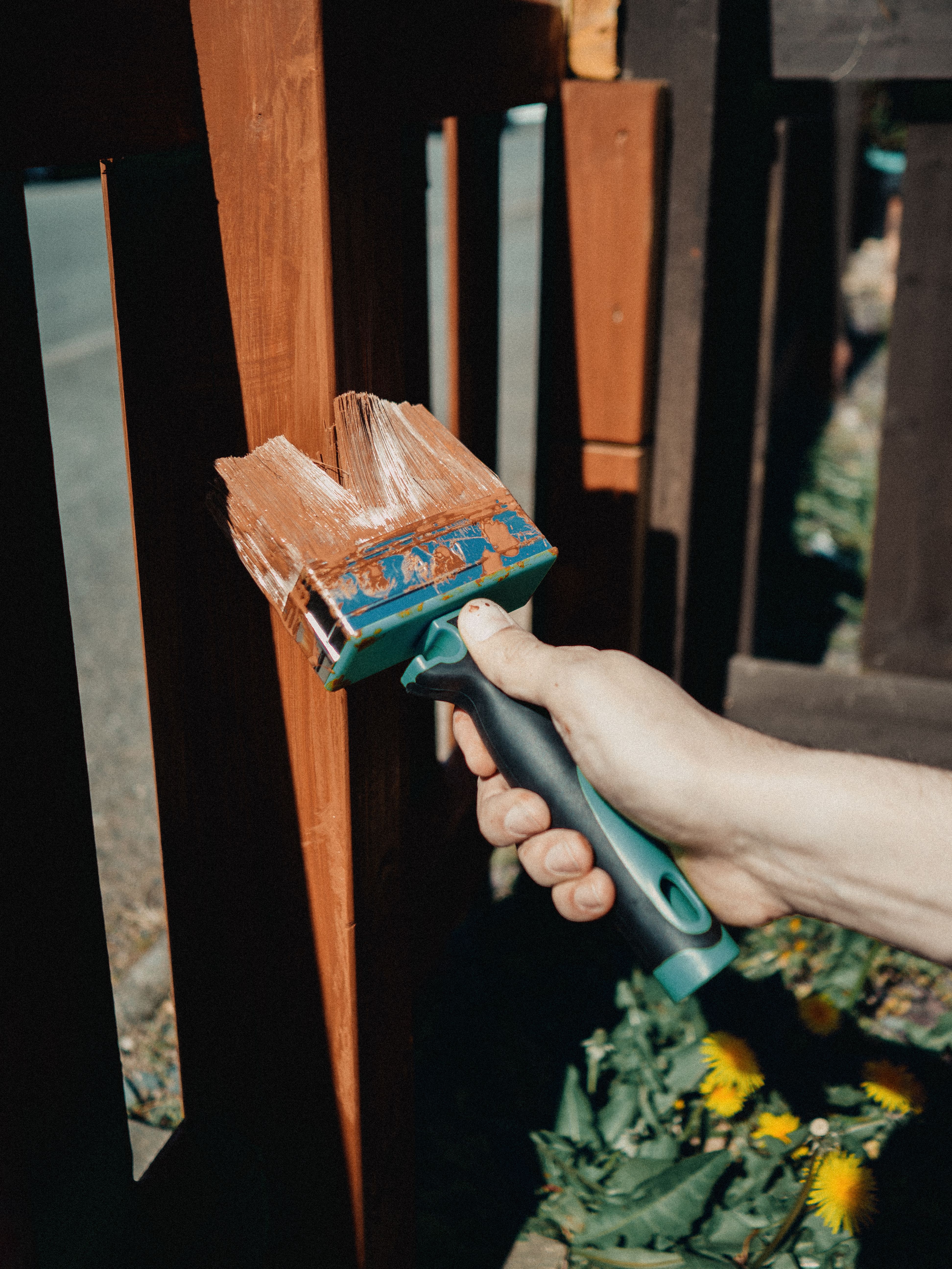 contractor staining brown deck railing