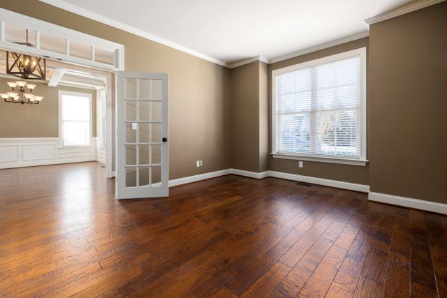 Freshly painted interior living room with tan interior paint and red brown flooring