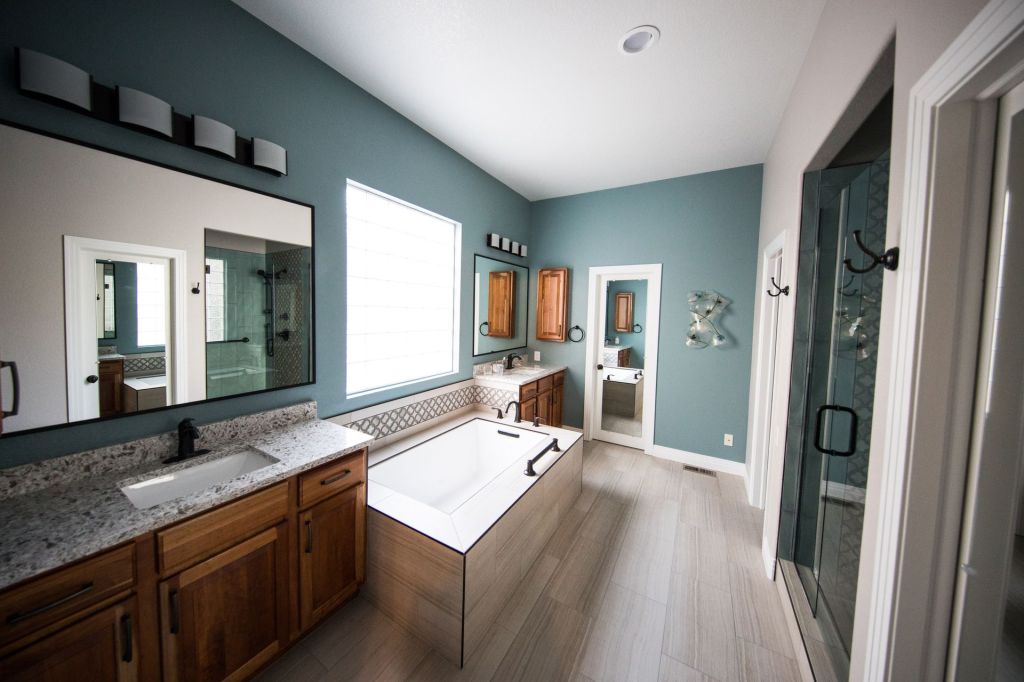 remodeled bathroom with green interior paint and white ceramic tile