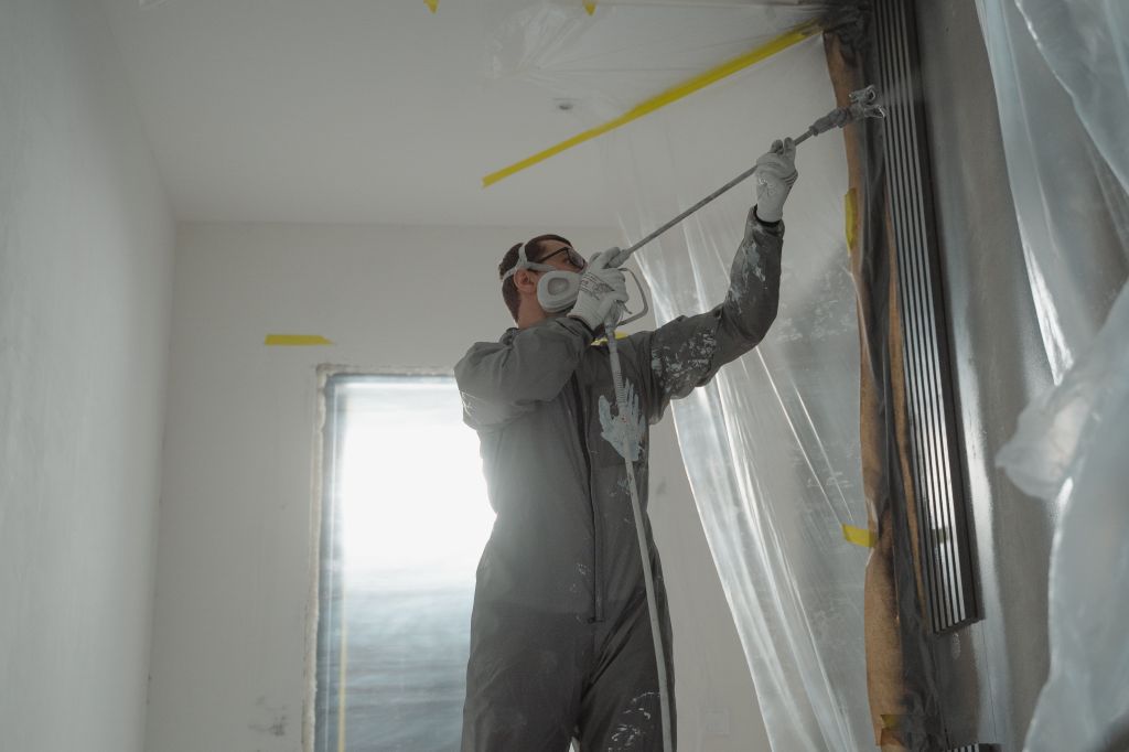 Painting contractor completing interior painting job